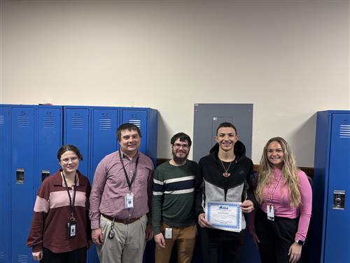Kaiden Beaumont, Wilson's Stairclimber for December, poses with his award plaque.
